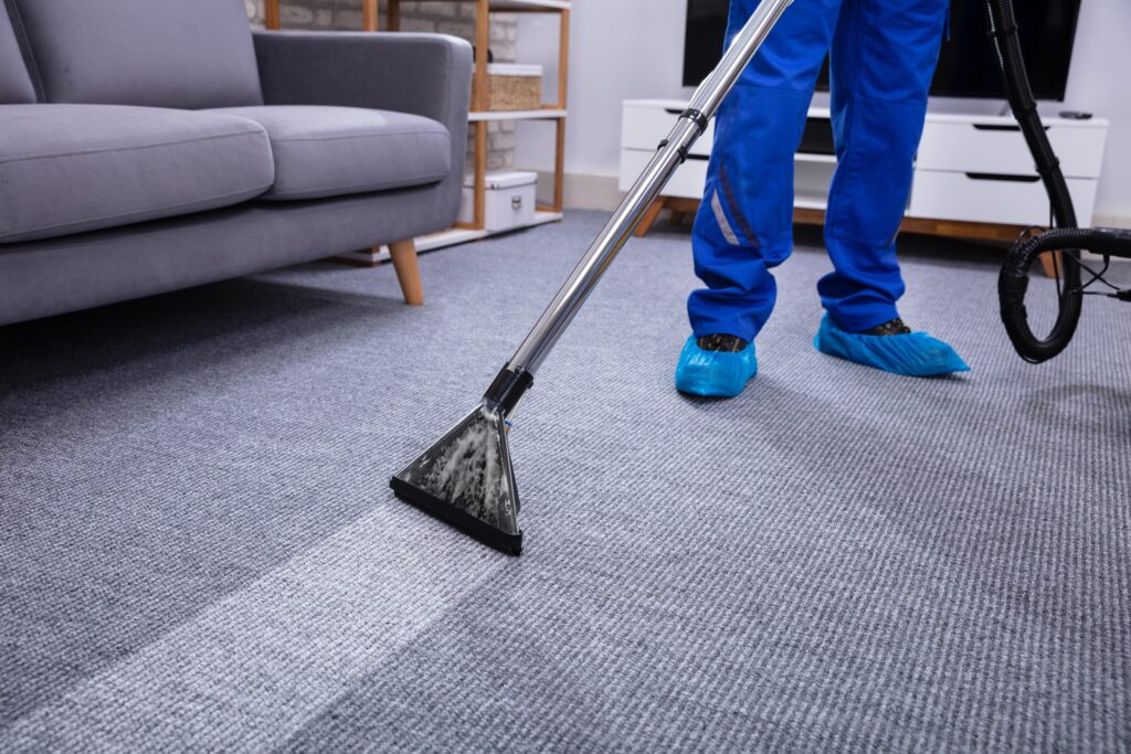male-janitor-cleaning-carpet-min